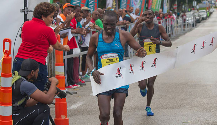 KENYAN PRIDE: Kenyan Stephen Mburi Njoroge crosses the line to win the Trinidad and Tobago International Marathon in a time of 2:23:04.3. His brother Simon(background) came in second with a time of 2:23:05. KENYAN PRIDE: Kenyan Stephen Mburi Njoroge crosses the line to win the Trinidad and Tobago International Marathon in a time of 2:23:04.3. His brother Simon(background) came in second with a time of 2:23:05.