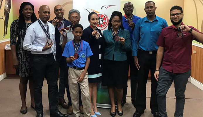 Runners, who completed the BAFA Sports/TTOC Virtual 5K, pose with their medals during a distribution ceremony at TTOC Olympic House, Abercromby St, Port of Spain, yesterday. Runners, who completed the BAFA Sports/TTOC Virtual 5K, pose with their medals during a distribution ceremony at TTOC Olympic House, Abercromby St, Port of Spain, yesterday.