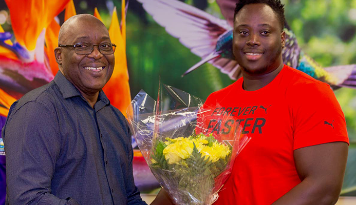 Chief Secretary Kelvin Charles presents 2019 Parapan Am double medallist Akeem Stewart with a bouquet of flowers at a ceremony to welcome him home on Tuesday at the ANR Robinson International Airport. Chief Secretary Kelvin Charles presents 2019 Parapan Am double medallist Akeem Stewart with a bouquet of flowers at a ceremony to welcome him home on Tuesday at the ANR Robinson International Airport.