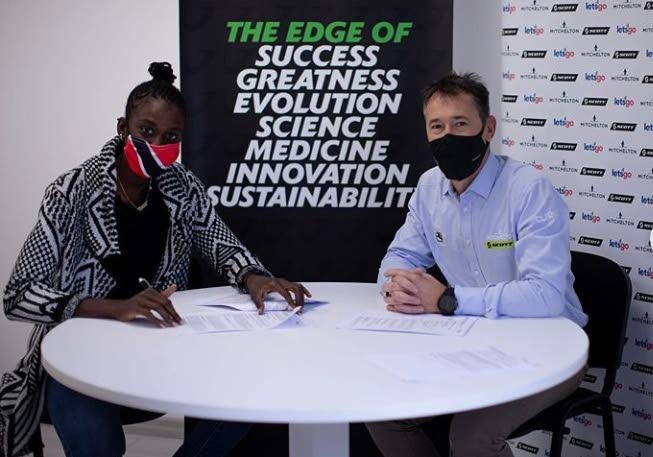 TT cyclist Teniel Campbell, left, signs a two-year contract with Australian team Mitchelton-Scott in Italy recently. - TT cyclist Teniel Campbell, left, signs a two-year contract with Australian team Mitchelton-Scott in Italy recently. -