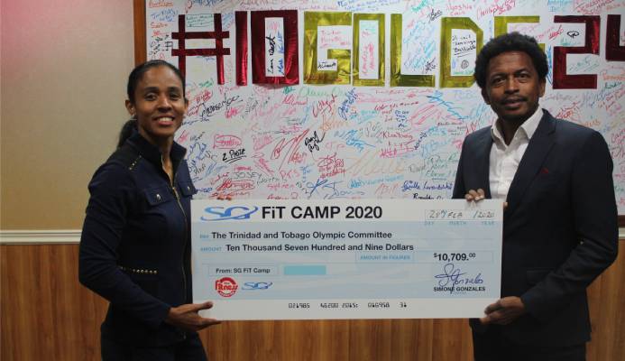Fitness Instructor Extraordinaire Simone Gonzales of the Fitness Center Ltd delivers proceeds from her recently concluded Fitness Camp, to TTOC president, Mr. Brian Lewis. Fitness Instructor Extraordinaire Simone Gonzales of the Fitness Center Ltd delivers proceeds from her recently concluded Fitness Camp, to TTOC president, Mr. Brian Lewis.