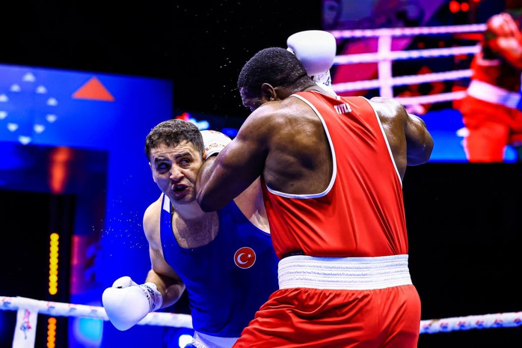 TT heavyweight boxer Nigel Paul (R) and Turkey's Berat Acar fight during the International Boxing Association World Championships 2021 +92kg quater-final match, in Belgrade, Serbia, on Tuesday. - Photo courtesy AIBA TT heavyweight boxer Nigel Paul (R) and Turkey's Berat Acar fight during the International Boxing Association World Championships 2021 +92kg quater-final match, in Belgrade, Serbia, on Tuesday. - Photo courtesy AIBA