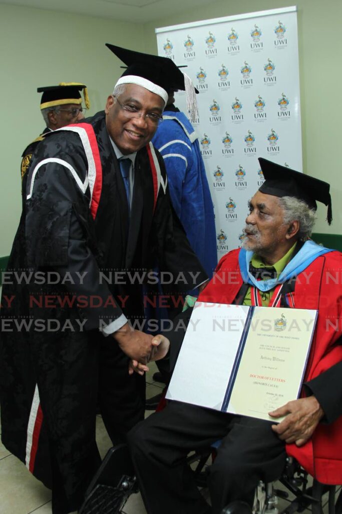 Tony 'Muffman' Williams, right, is congratulated by Prof Brian Copeland on his honorary doctor of letters degree from UWI at a graduation ceremony in October 2016. - FILE PHOTO Tony 'Muffman' Williams, right, is congratulated by Prof Brian Copeland on his honorary doctor of letters degree from UWI at a graduation ceremony in October 2016. - FILE PHOTO