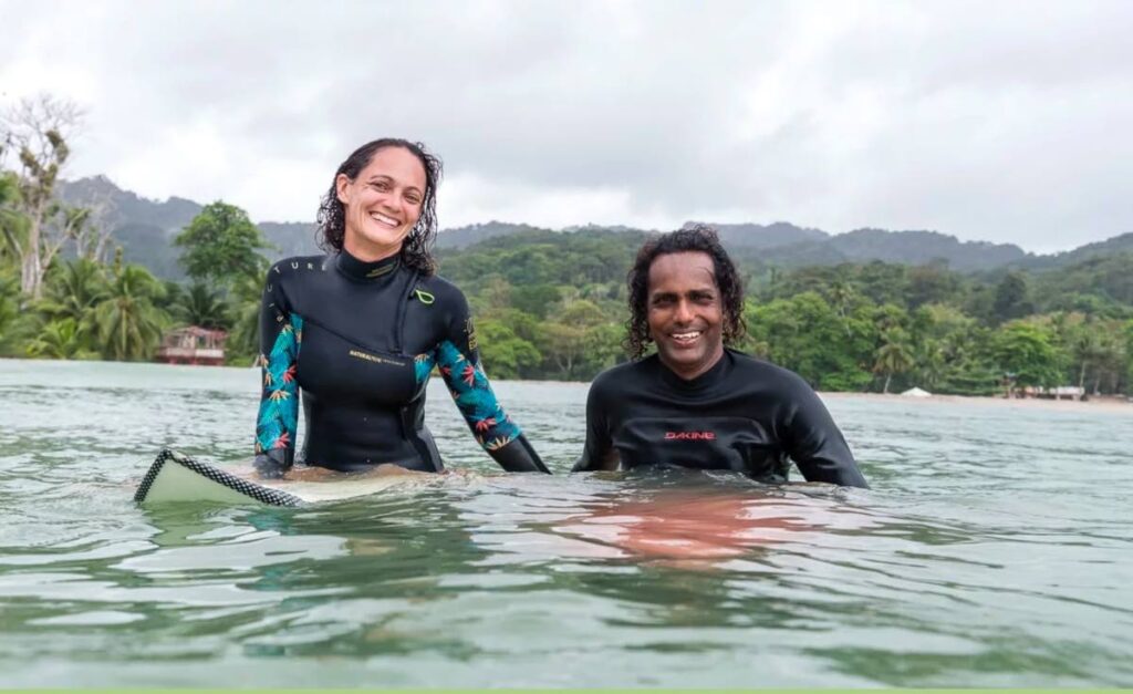 Manuela Giger instructs a surf therapy participant on how to stand on a surfboard. PHOTO COURTESY OMARION BUTLER. - Manuela Giger instructs a surf therapy participant on how to stand on a surfboard. PHOTO COURTESY OMARION BUTLER. -