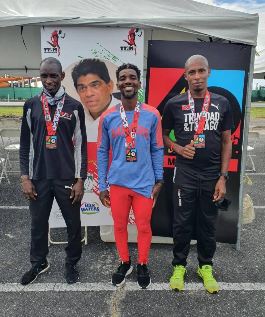 TTIM winner Kelvin Johnson (Guyana), centre, with second placed Elvis Turner, left, and third placed Curtis Cox. - TTIM winner Kelvin Johnson (Guyana), centre, with second placed Elvis Turner, left, and third placed Curtis Cox. -