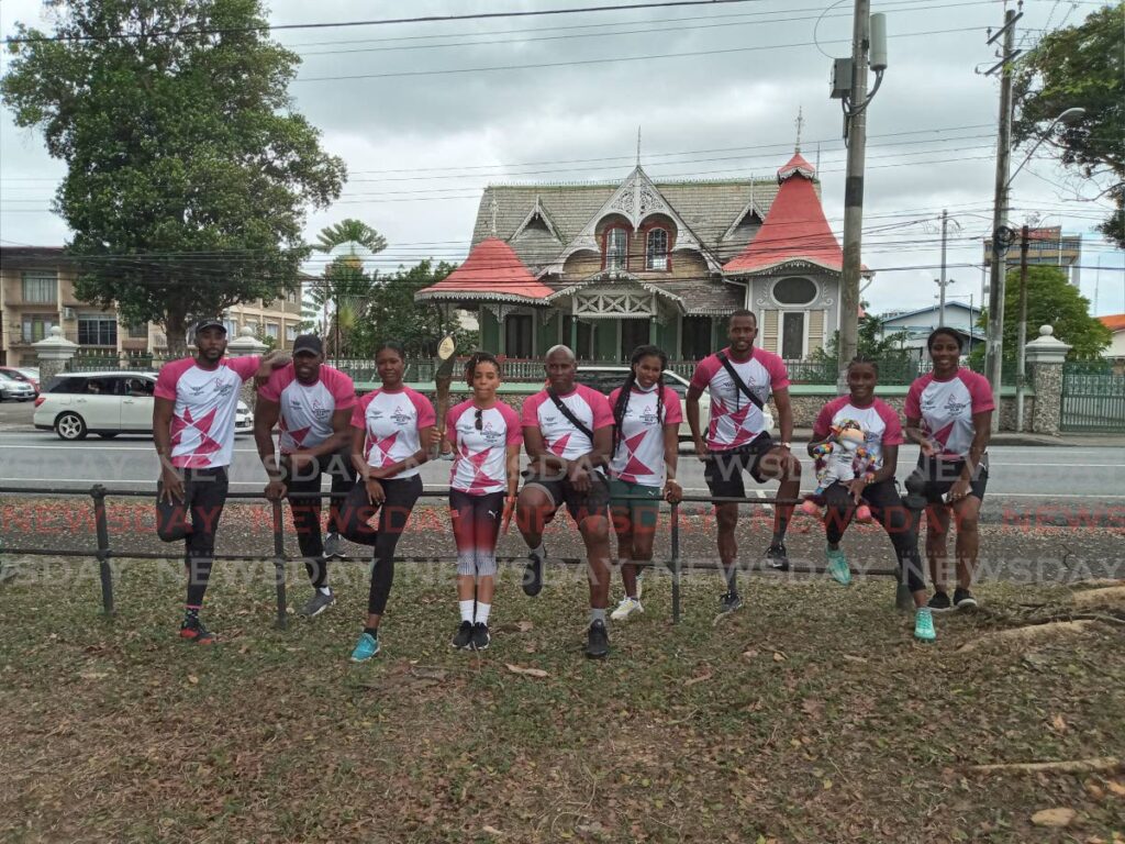 TT women's boxer Tianna Guy, fourth from left, holds the Queen's Baton at the Queen's Park Savannah in Port of Spain, on Wednesday. She is joined by national athletes and former athletes. - Jelani Beckles TT women's boxer Tianna Guy, fourth from left, holds the Queen's Baton at the Queen's Park Savannah in Port of Spain, on Wednesday. She is joined by national athletes and former athletes. - Jelani Beckles