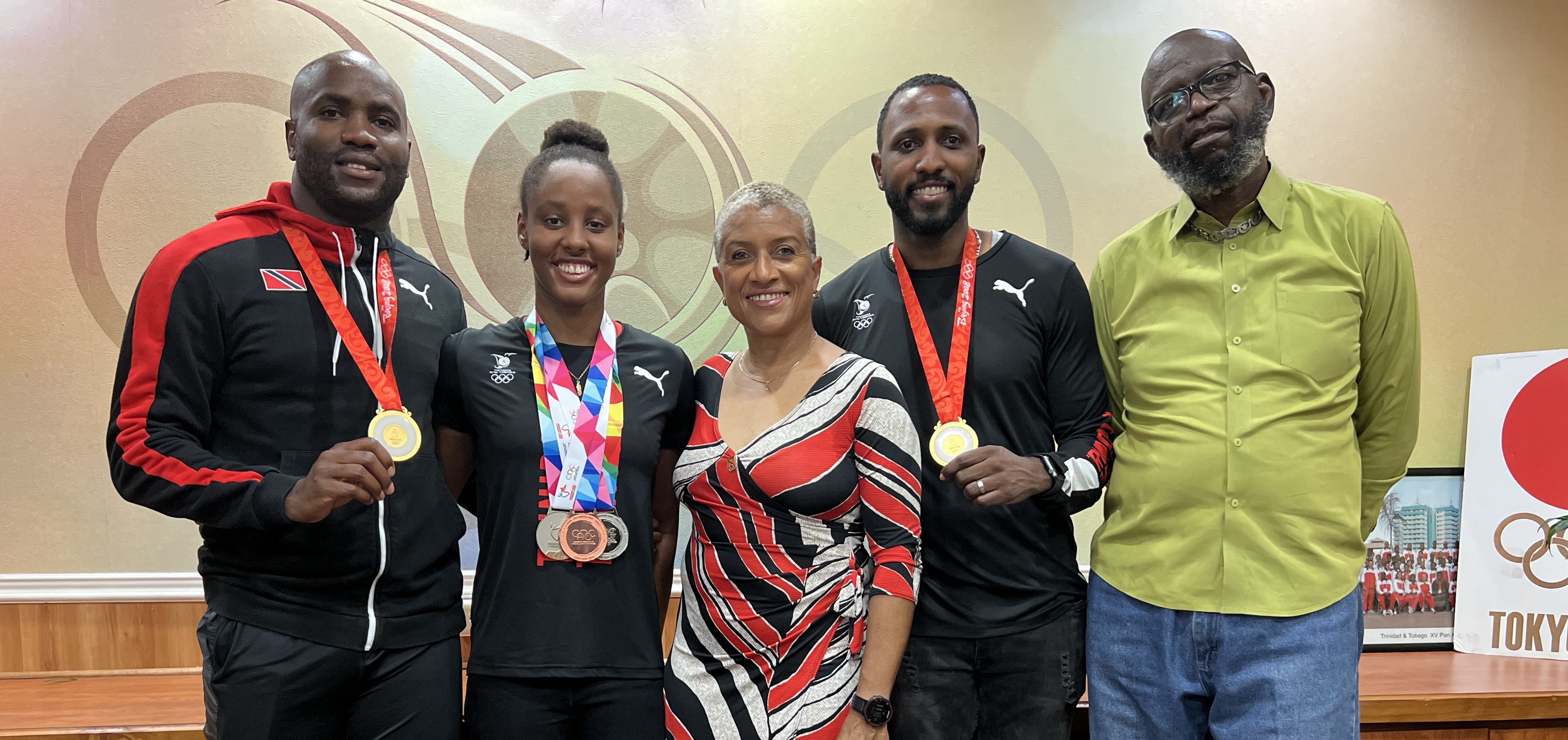 Pictured (from left) are Emmanuel Callender (Olympic Gold Medalist), Jamiah Harley (National Swimmer), Diane Henderson (TTOC/TTCGA President), Richard Thompson (Olympic Gold Medalist) and the father of Aqell Joseph (National Swimmer) Pictured (from left) are Emmanuel Callender (Olympic Gold Medalist), Jamiah Harley (National Swimmer), Diane Henderson (TTOC/TTCGA President), Richard Thompson (Olympic Gold Medalist) and the father of Aqell Joseph (National Swimmer)
