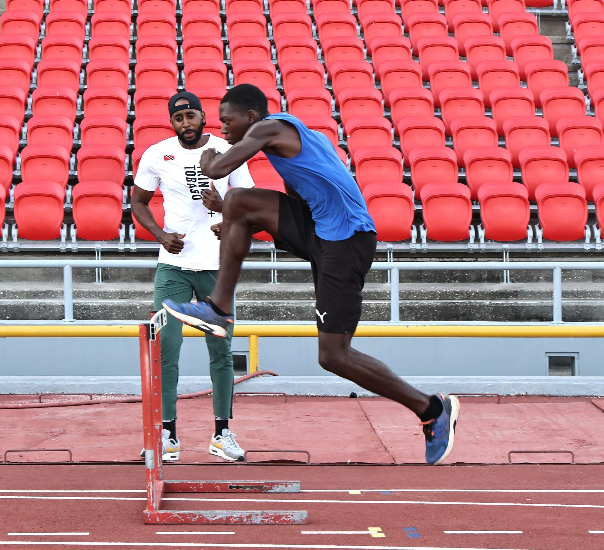 FILE: Former 400 metres hurdles champion Jehue Gordon, left, looks on as hurdler Tyrique Vincent goes through his routine during a training session for Carifta Athletes at the Hasley Crawford Stadium, Mucurapo, earlier this year.  ABRAHAM DIAZ (Image obtained at guardian.co.tt) FILE: Former 400 metres hurdles champion Jehue Gordon, left, looks on as hurdler Tyrique Vincent goes through his routine during a training session for Carifta Athletes at the Hasley Crawford Stadium, Mucurapo, earlier this year.  ABRAHAM DIAZ (Image obtained at guardian.co.tt)
