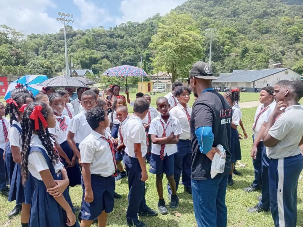 TT American Flag Football Association (TTAFF) vice-president Allan Checkley (second from right) discusses the sport of flag football with students of the Maracas SDA Primary School on June 9. - Photo courtesy TTAFF (Image obtained at newsday.co.tt)