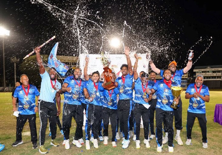 CHAMPS ONCE AGAIN: Queen’s Park Cricket Club players and management staff celebrate with the Premiership 1 T20 trophy after defeating Clarke Road United in the final of the CPL/TKR T20 Festival, at the Queen’s Park Oval in Port of Spain, on Saturday night. —Photo courtesy Red Force Cricket Facebook Page (Image obtained at trinidadexpress.com)
