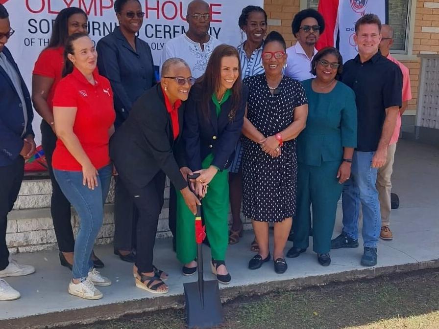 HISTORIC: Trinidad and Tobago Olympic Committee president, Diane Henderson, left centre, front, and Pan Am Sports Organisation secretary general Jimena Saldana, centre right front, turn the sod at the site of the new home of the organisation at 14 Robinsonville, Belmont, yesterday. Watching are members of the TTOC executive and former Olympic gold medallist Hasely Crawford, centre, back row, and immediate TTOC past president Brian Lewis, back row, second right. (Image obtained at trinidadexpress.com)