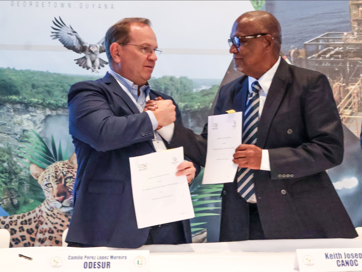 ANOC President Keith Joseph (right) and Camilo Pérez López Moreira, representing the Paraguay Olympic Committee, exchange signed documents following the official signing of a  Memorandum of Understanding to strengthen sport development and cooperation between the Caribbean and South America at the CANOC Annual General Assembly 2025 in Georgetown, Guyana. (Image obtained from CANOC Newsletter) ANOC President Keith Joseph (right) and Camilo Pérez López Moreira, representing the Paraguay Olympic Committee, exchange signed documents following the official signing of a  Memorandum of Understanding to strengthen sport development and cooperation between the Caribbean and South America at the CANOC Annual General Assembly 2025 in Georgetown, Guyana. (Image obtained from CANOC Newsletter)