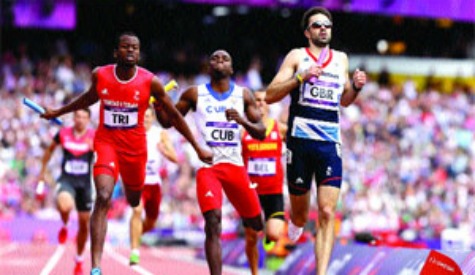 HARD FOUGHT: Trinidad and Tobago's Deon Lendore, left, Cuba's Omar Cisneros and Britain's Martyn Rooney cross the finish line in their heat of the men's 4x400-metre relay in the Olympic Stadium at the 2012 Summer Olympics in London, yesterday. Lendore and the rest of the T&T quartet–Ade Alleyne-Forte, Lalonde Gordon and Jarrin Solomon--won the heat, clocking three minutes, 00.38 seconds—a new national record. The final takes place today (4.20 p.m. T&T time). –Photo: AP