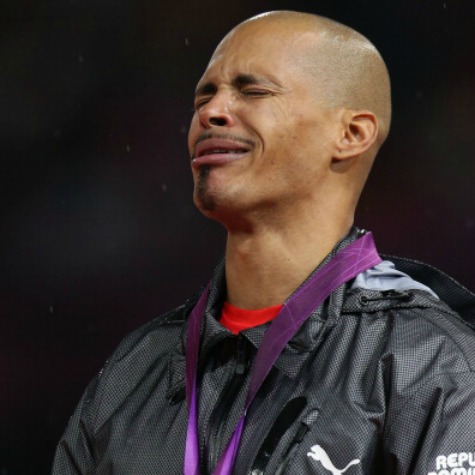 Dominican Republic's Felix Sanchez, the 400 metres hurdles champion, remembers his grandmother on the podium