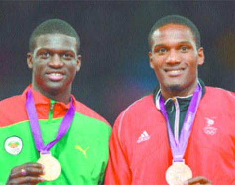 caribbean celebration: Grenada's gold medallist Kirani James, left, and Trinidad and Tobago's bronze medallist Lalonde Gordon celebrate on the podium of the men's 400m at the athletics event during the London 2012 Olympic Games yesterday in London