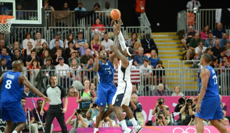 LeBron James of the US shoots versus Florent Pietrus of France in front of a packed crowd at the London 2012 Olympic Park Basketball Arena