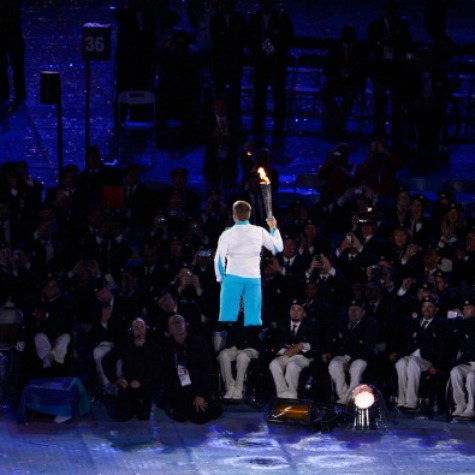 The flame is carried into the Olympic Stadium by Royal Marine Joe Townsend during the Opening Ceremony of the London 2012 Paralympics